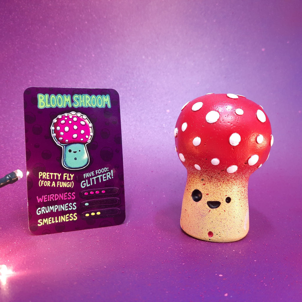 Mushroom figurine with a card labeled 'Bloom Shroom' on a purple background