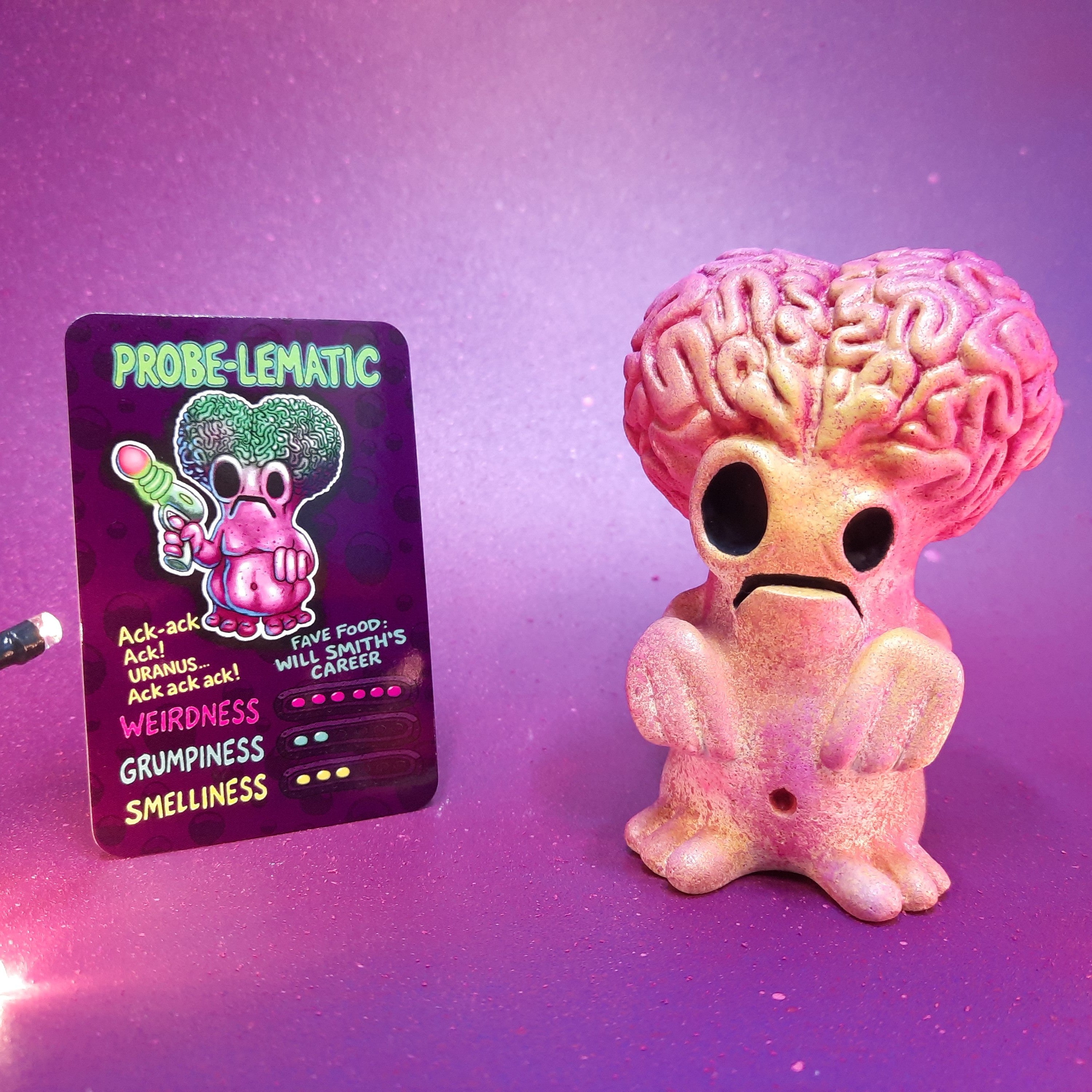 Probe-lematic alien  Flobbazoid figurine with brain head, inspired by mars attacks, and specimen card.