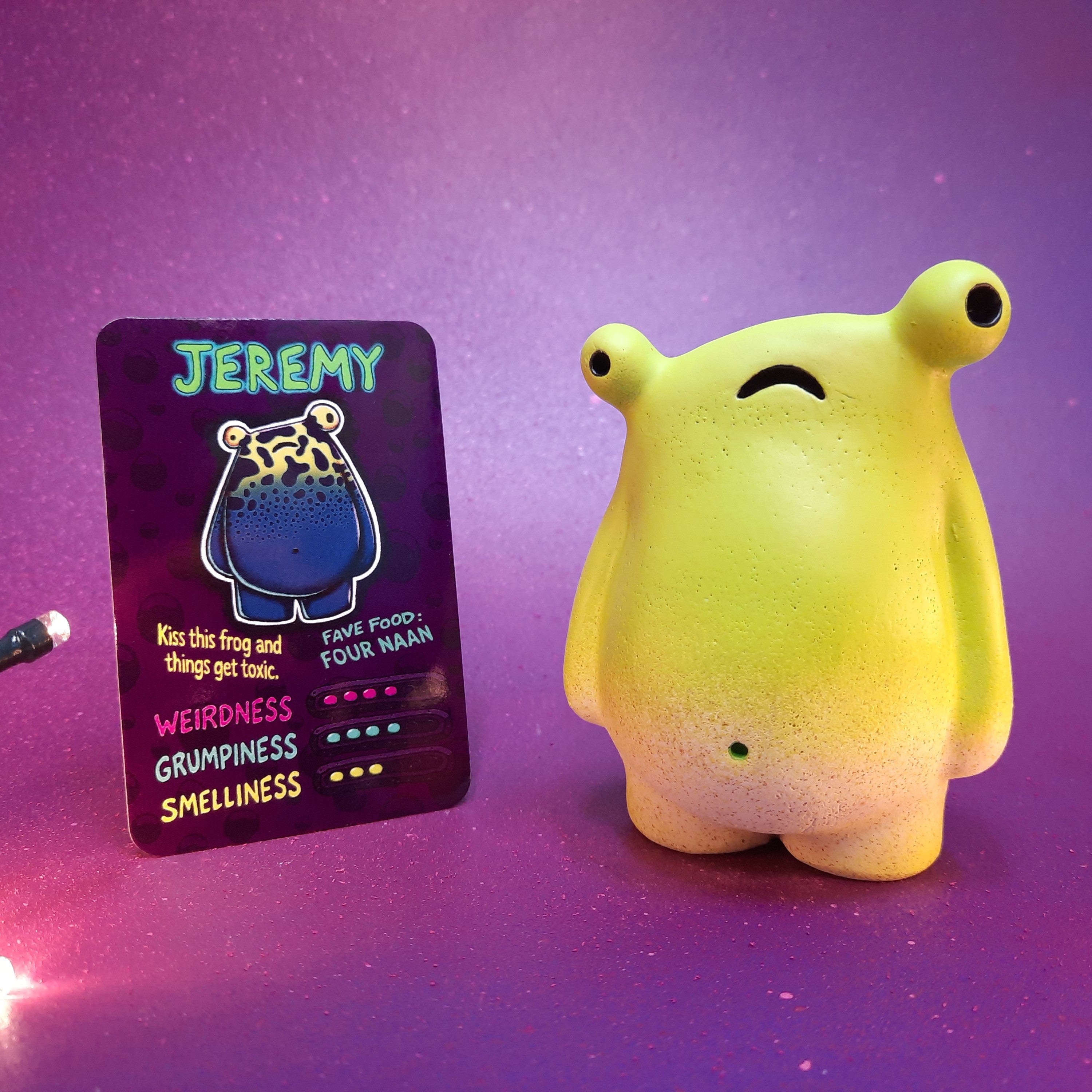Jeremy frog-like Flobbazoid figurine painted green with its specimen card.