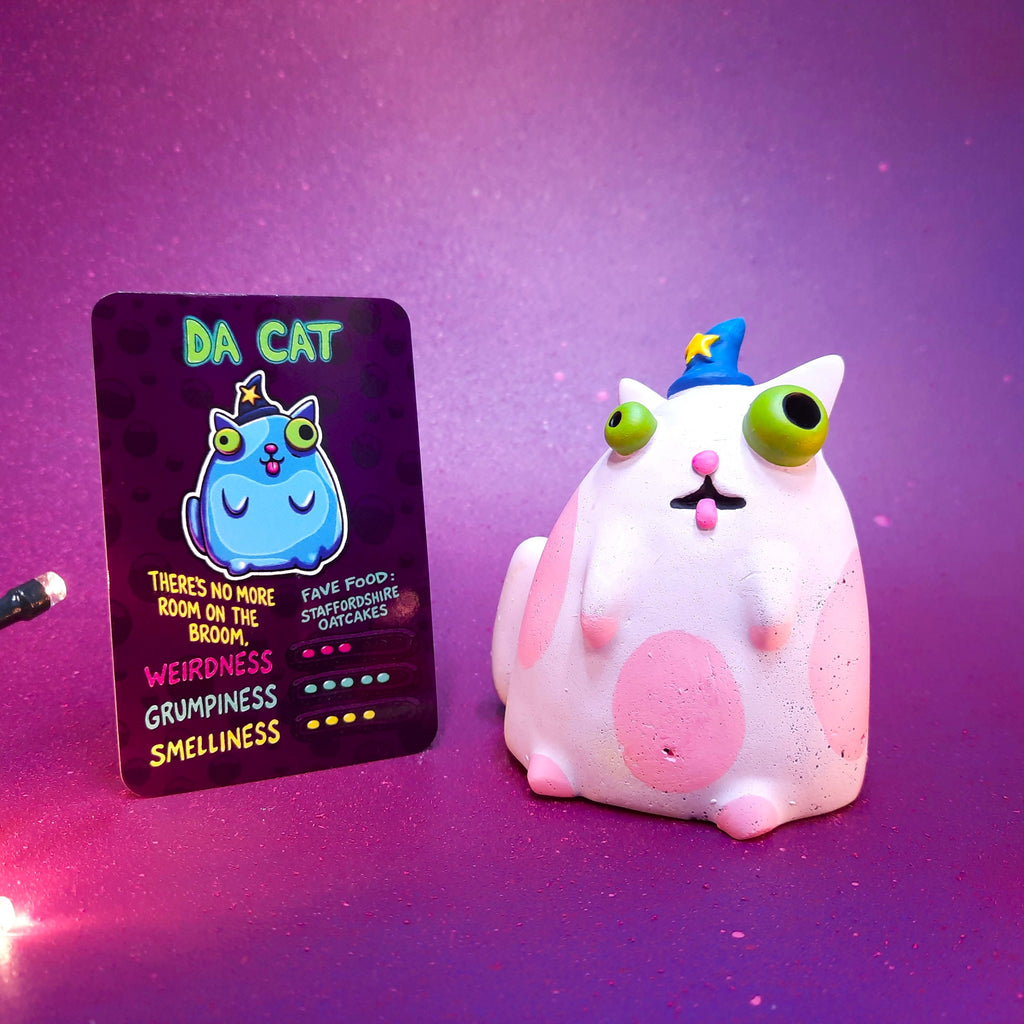 Cute cat figurine with a matching card on a purple background